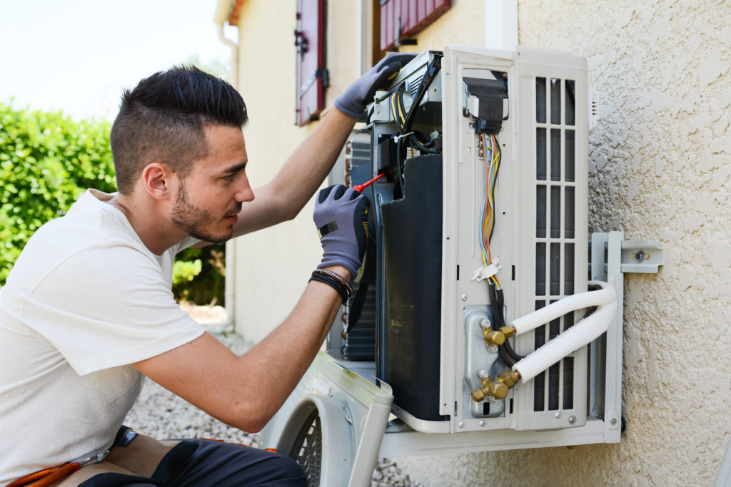 professional technician working on a refrigerated air unit