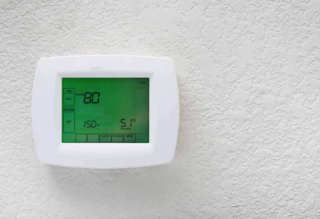 digital thermostat on a white wall