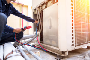 Technician is checking air conditioner and heater maintenance ,measuring equipment for filling air conditioners.