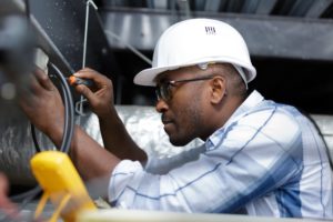 electrician working on a fuse box