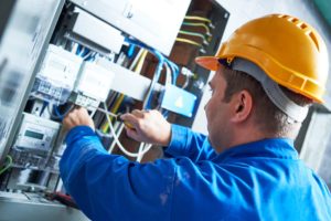 Electrician working on a fuse box