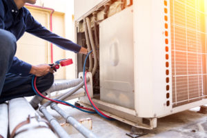 An HVAC contractor servicing an HVAC system at an El Paso home.
